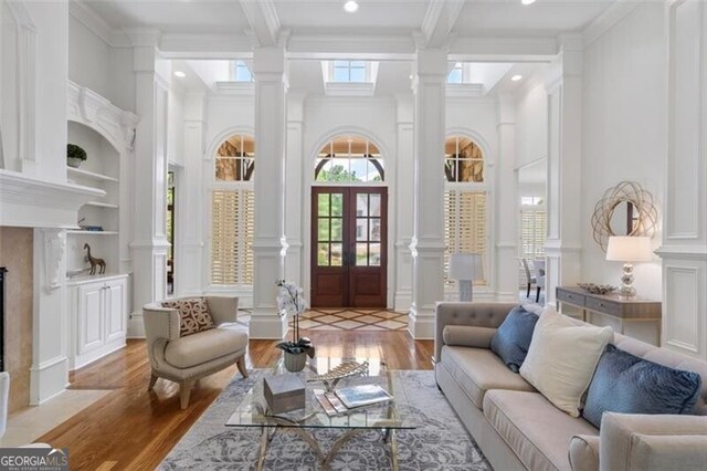 4634 Whitestone Way, Suwanee, GA 30024 - living room featuring decorative columns, light wood-style flooring, ornamental molding, recessed lighting, and beamed ceiling