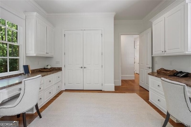4634 Whitestone Way, Suwanee, GA 30024 - office featuring built in desk, wood finished floors, and ornamental molding