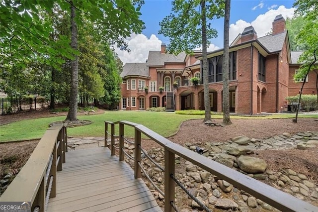 4634 Whitestone Way, Suwanee, GA 30024 - back of house with a chimney, a sunroom, brick siding, and stairway