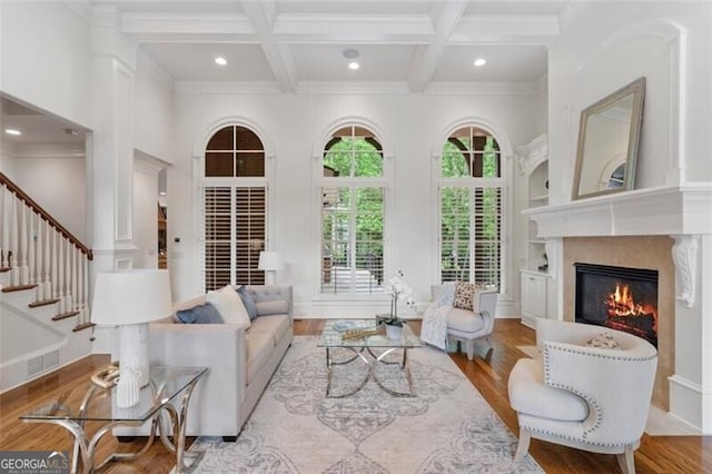 4634 Whitestone Way, Suwanee, GA 30024 - living area featuring ornamental molding, wood finished floors, coffered ceiling, a high end fireplace, and recessed lighting