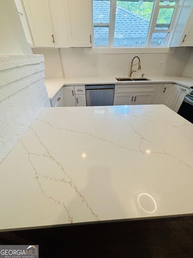 1460 Hartford Ave SW, Atlanta, GA 30310 - kitchen with dishwasher, white cabinetry, healthy amount of natural light, and light stone counters