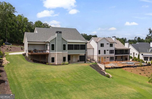 4445 Pebble Rock Dr, Cumming, GA 30041 - back of property with a sunroom, a lawn, and a chimney