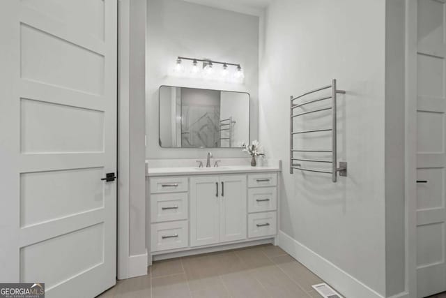 4445 Pebble Rock Dr, Cumming, GA 30041 - full bathroom featuring a towel warming rack, tile patterned floors, vanity, and a shower