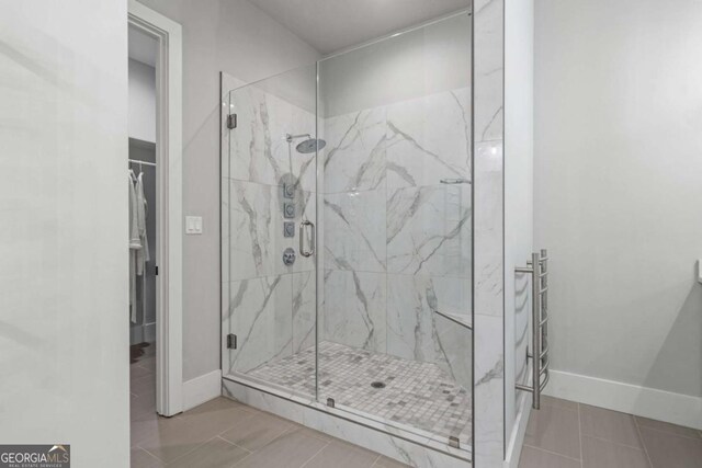 4445 Pebble Rock Dr, Cumming, GA 30041 - bathroom with a marble finish shower, tile patterned flooring, and a walk in closet