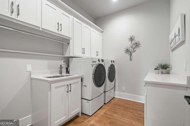 4445 Pebble Rock Dr, Cumming, GA 30041 - laundry area with separate washer and dryer, cabinet space, light wood-type flooring, and recessed lighting