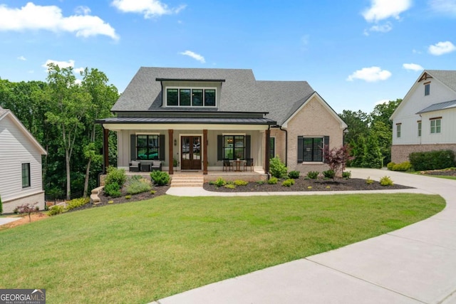 4445 Pebble Rock Dr, Cumming, GA 30041 - view of front of home with a porch, a standing seam roof, a front yard, a metal roof, and roof with shingles