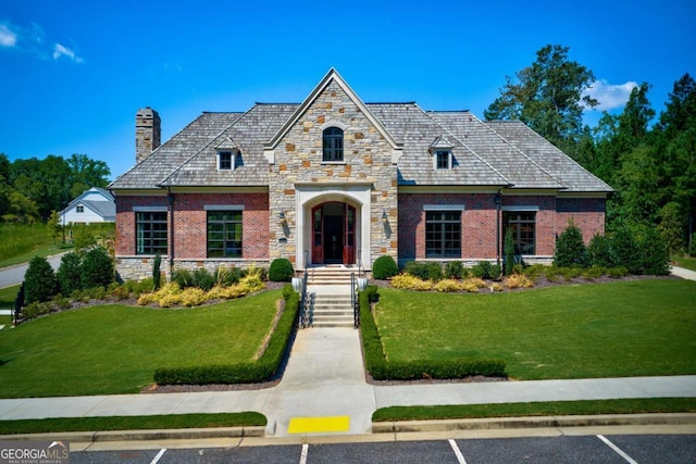 4445 Pebble Rock Dr, Cumming, GA 30041 - view of front of property with uncovered parking, a chimney, stone siding, and a front lawn