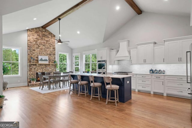 4445 Pebble Rock Dr, Cumming, GA 30041 - kitchen with high vaulted ceiling, custom exhaust hood, beamed ceiling, ceiling fan, and decorative backsplash