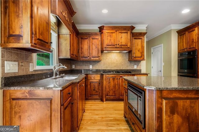 205 Camden Creek Ct, Lawrenceville, GA 30043 - kitchen featuring double oven, built in microwave, light wood-type flooring, gas stovetop, and crown molding