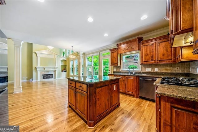 205 Camden Creek Ct, Lawrenceville, GA 30043 - kitchen with dishwasher, open floor plan, a fireplace, light wood-style flooring, and backsplash