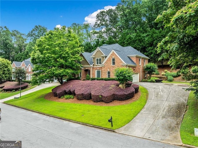 205 Camden Creek Ct, Lawrenceville, GA 30043 - view of front facade featuring concrete driveway, brick siding, an attached garage, and a front yard