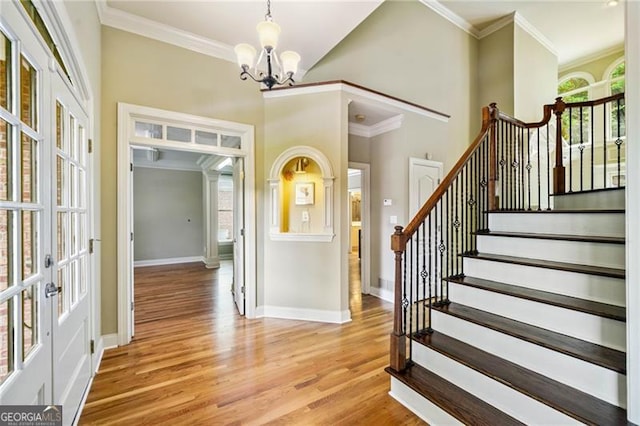 205 Camden Creek Ct, Lawrenceville, GA 30043 - foyer with plenty of natural light, a chandelier, light wood-type flooring, crown molding, and stairs