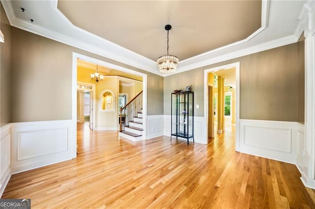 205 Camden Creek Ct, Lawrenceville, GA 30043 - empty room with a chandelier, a tray ceiling, stairway, ornamental molding, and light wood finished floors