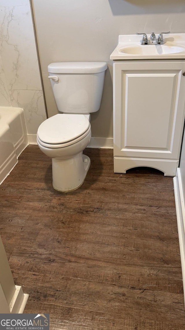 6197 Union Grove Rd, Lithia Springs, GA 30122 - full bath with wood finished floors, a bathtub, vanity, and a shower