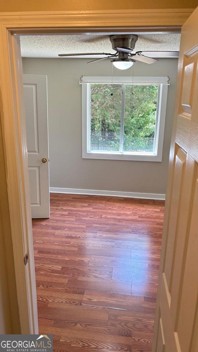 6197 Union Grove Rd, Lithia Springs, GA 30122 - unfurnished dining area featuring wood finished floors and ceiling fan