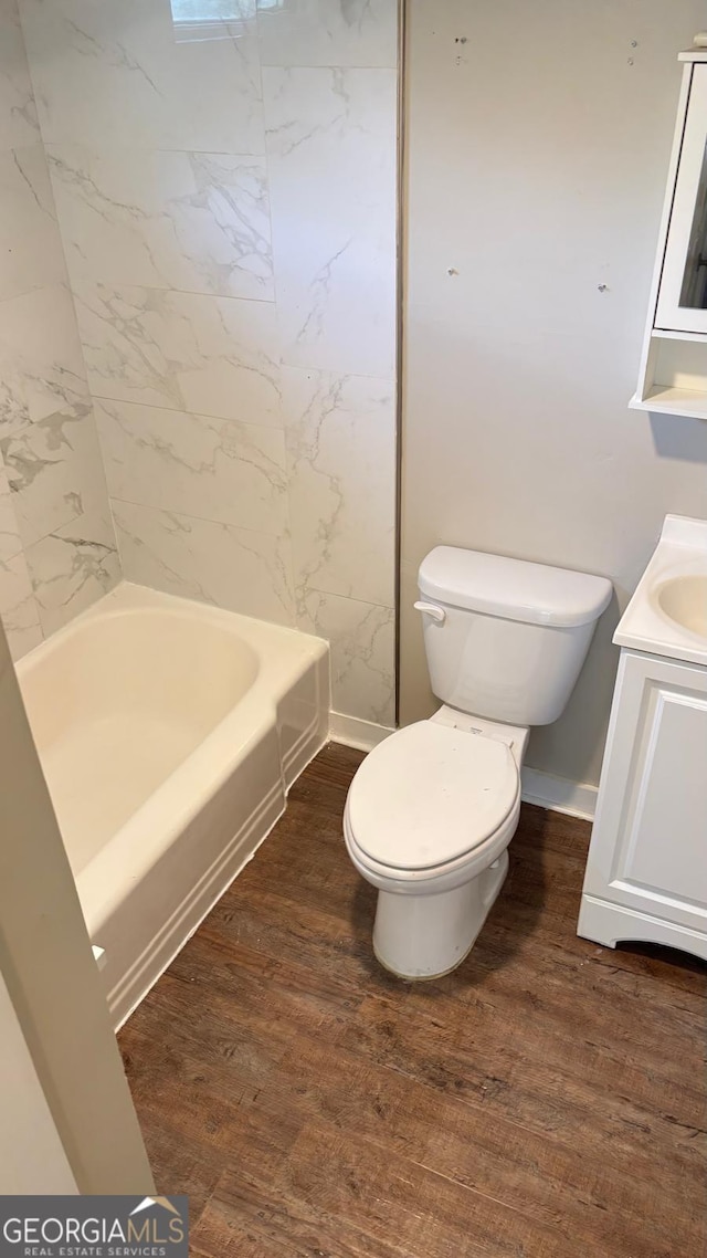 6197 Union Grove Rd, Lithia Springs, GA 30122 - bathroom featuring vanity, wood finished floors, and shower / washtub combination