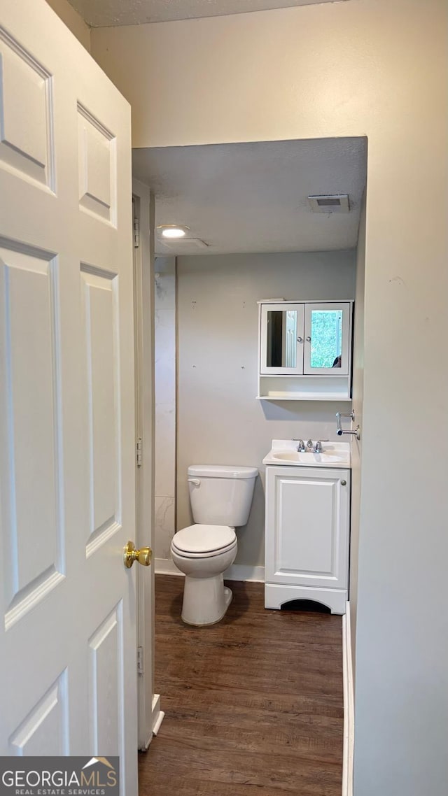 6197 Union Grove Rd, Lithia Springs, GA 30122 - half bath featuring vanity and wood finished floors