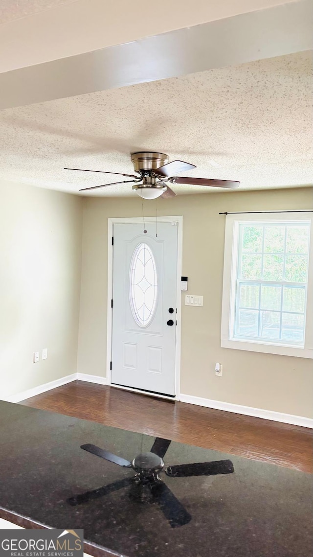 6197 Union Grove Rd, Lithia Springs, GA 30122 - entryway with a ceiling fan, dark wood finished floors, and a textured ceiling
