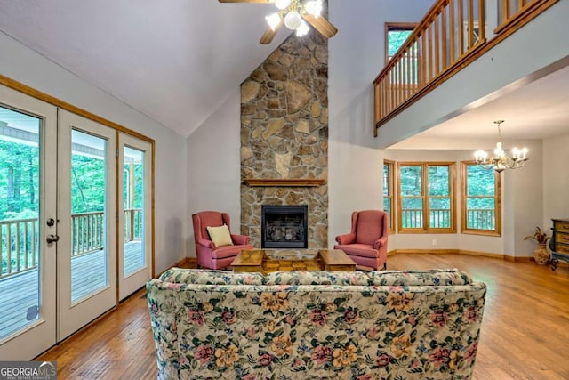 215 Souther Meadow Dr, Blairsville, GA 30512 - living area featuring wood finished floors, plenty of natural light, a stone fireplace, ceiling fan, and high vaulted ceiling
