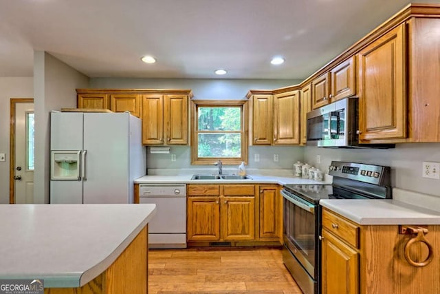 215 Souther Meadow Dr, Blairsville, GA 30512 - kitchen featuring appliances with stainless steel finishes, light wood-type flooring, light countertops, brown cabinets, and recessed lighting