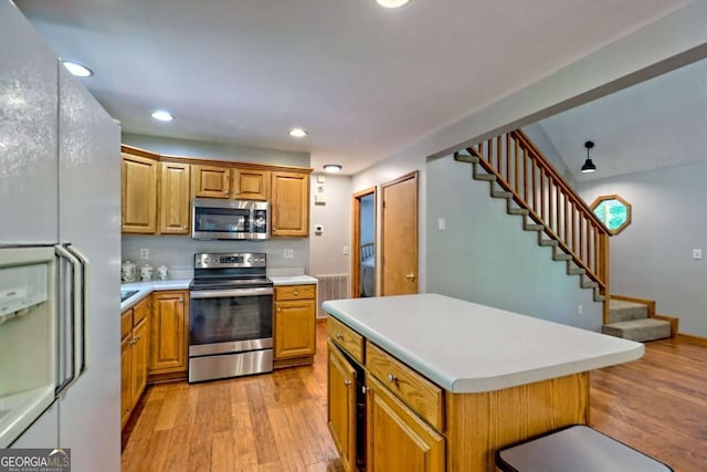 215 Souther Meadow Dr, Blairsville, GA 30512 - kitchen with appliances with stainless steel finishes, light wood-style flooring, light countertops, recessed lighting, and a kitchen island