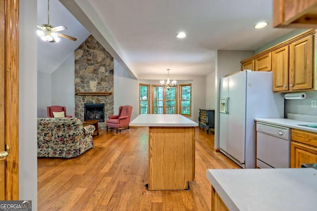 215 Souther Meadow Dr, Blairsville, GA 30512 - kitchen featuring white appliances, a fireplace, a kitchen island, light countertops, and lofted ceiling