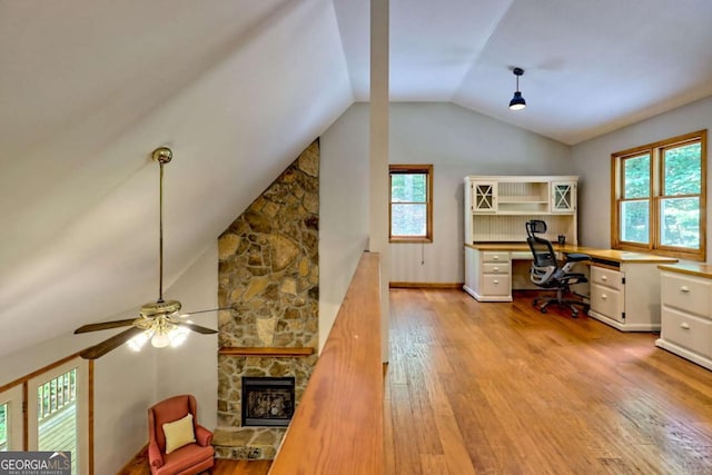 215 Souther Meadow Dr, Blairsville, GA 30512 - office area with vaulted ceiling, light wood finished floors, a stone fireplace, ceiling fan, and built in study area