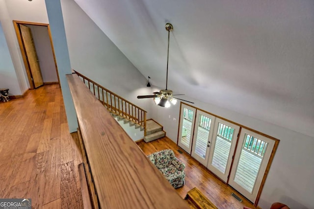 215 Souther Meadow Dr, Blairsville, GA 30512 - living area with vaulted ceiling, wood finished floors, a ceiling fan, and stairs