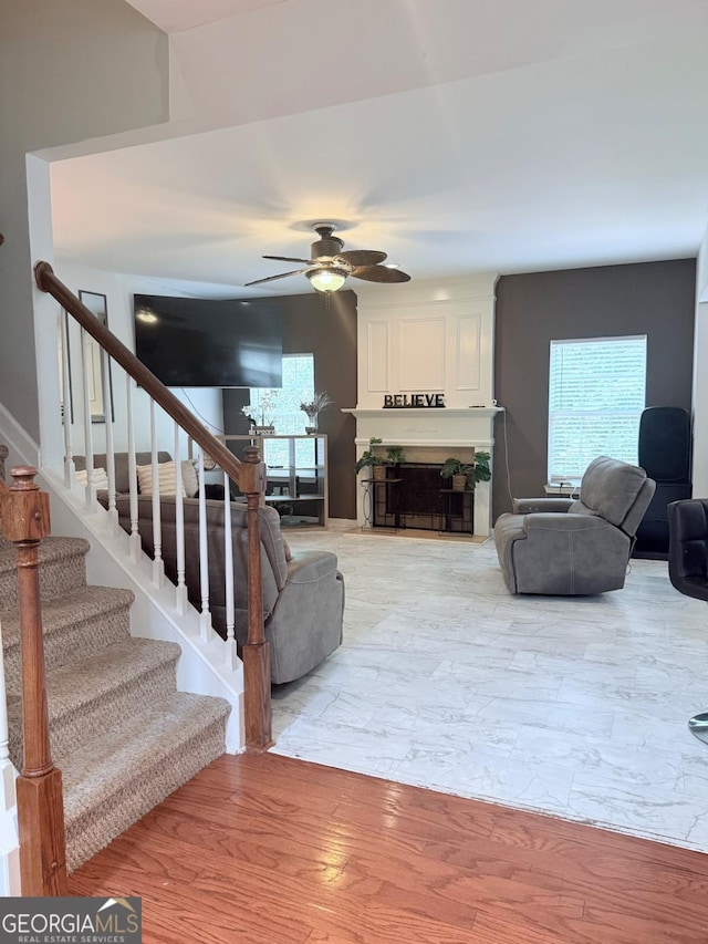 3439 Tupelo Trl, Auburn, GA 30011 - living room with ceiling fan, stairs, and a large fireplace