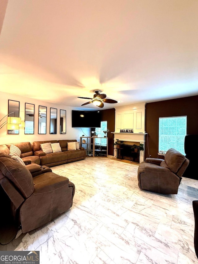 3439 Tupelo Trl, Auburn, GA 30011 - living room featuring a ceiling fan, light marble finish floors, and a fireplace
