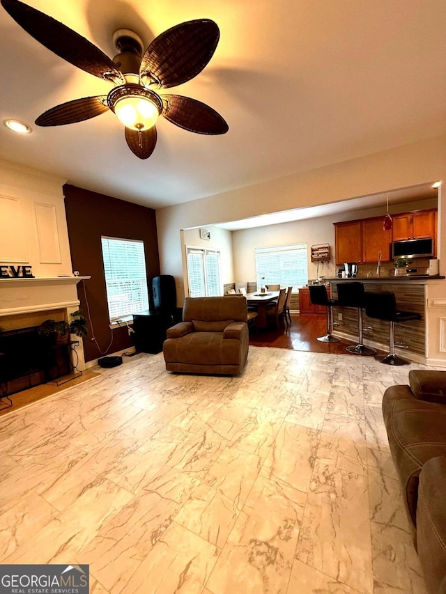 3439 Tupelo Trl, Auburn, GA 30011 - living area with ceiling fan, plenty of natural light, recessed lighting, and marble finish flooring
