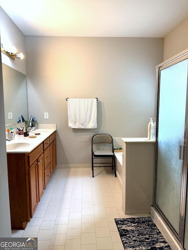 3439 Tupelo Trl, Auburn, GA 30011 - bathroom with double vanity, a bath, a stall shower, and tile patterned floors