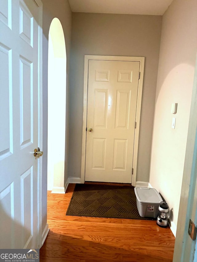 3439 Tupelo Trl, Auburn, GA 30011 - hallway featuring wood finished floors and arched walkways