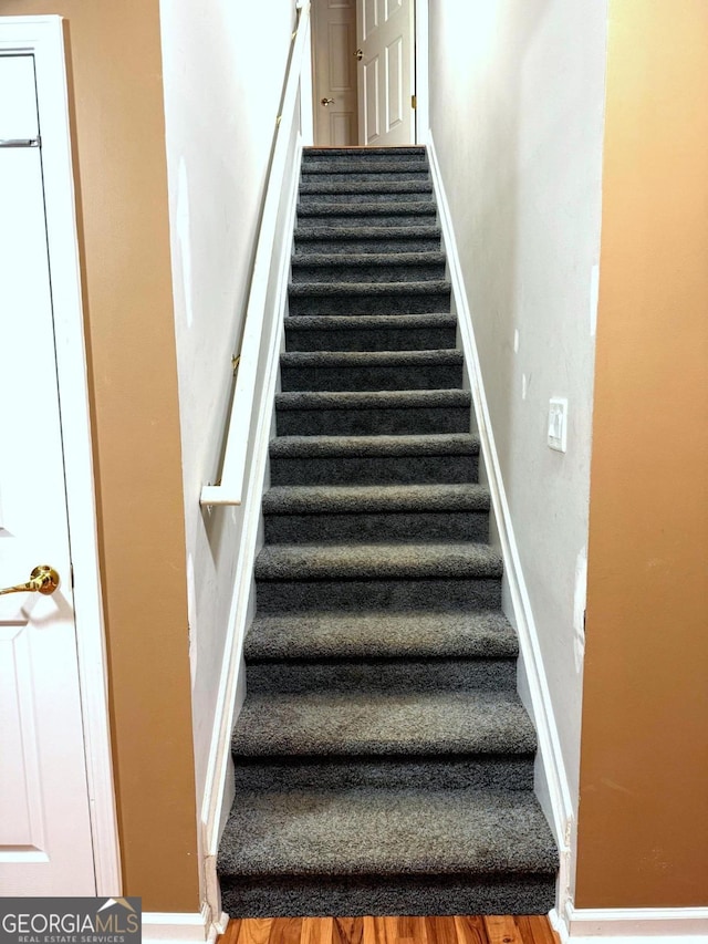 3439 Tupelo Trl, Auburn, GA 30011 - stairs featuring baseboards and wood finished floors
