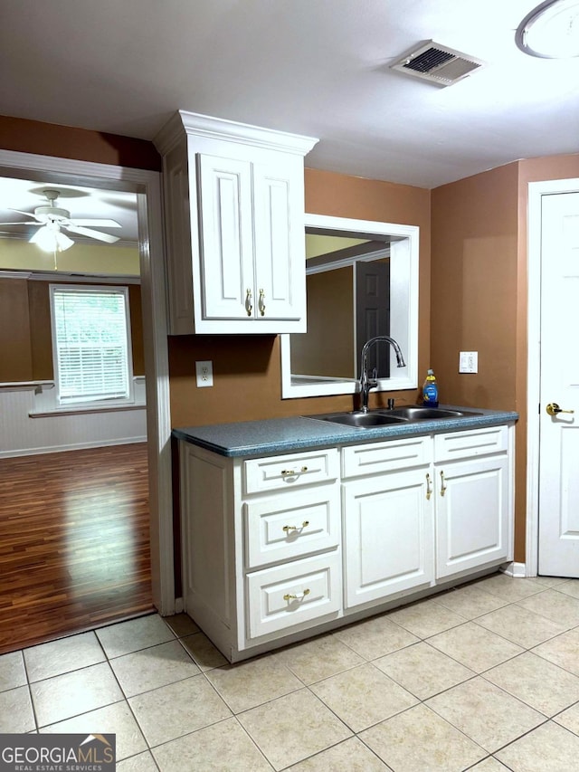 3439 Tupelo Trl, Auburn, GA 30011 - kitchen featuring dark countertops, white cabinets, ceiling fan, and light tile patterned floors