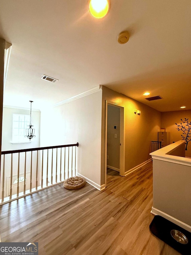 3439 Tupelo Trl, Auburn, GA 30011 - hallway with wood finished floors, an upstairs landing, crown molding, and recessed lighting
