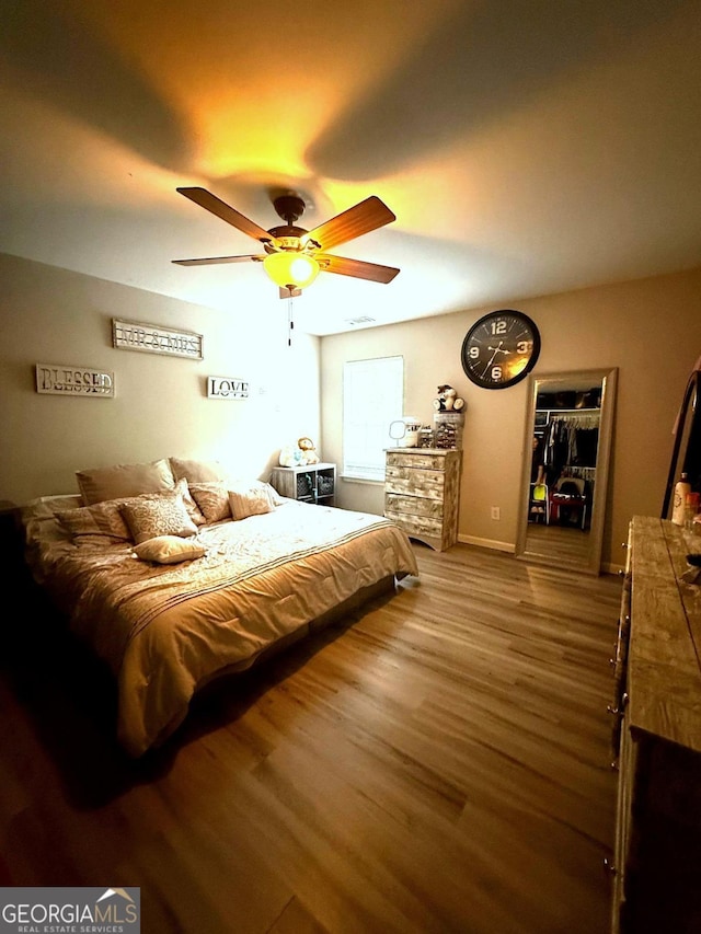 3439 Tupelo Trl, Auburn, GA 30011 - bedroom with wood finished floors and ceiling fan