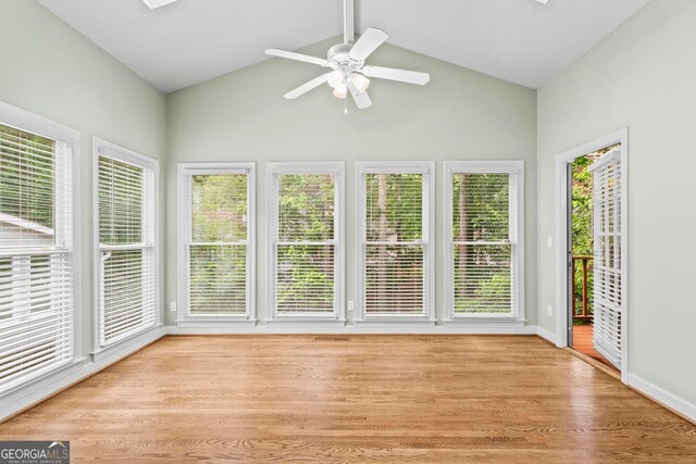 1605 Spinnaker Dr, Alpharetta, GA 30005 - unfurnished sunroom with high vaulted ceiling, a deck, wood finished floors, and a skylight