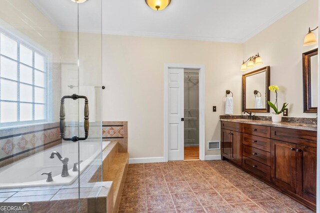 1605 Spinnaker Dr, Alpharetta, GA 30005 - full bath with double vanity, ornamental molding, a bath, tile patterned flooring, and a walk in closet