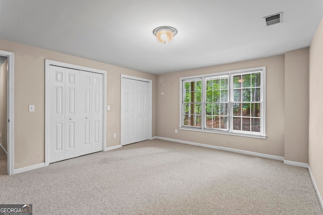 1605 Spinnaker Dr, Alpharetta, GA 30005 - unfurnished bedroom with carpet and multiple closets