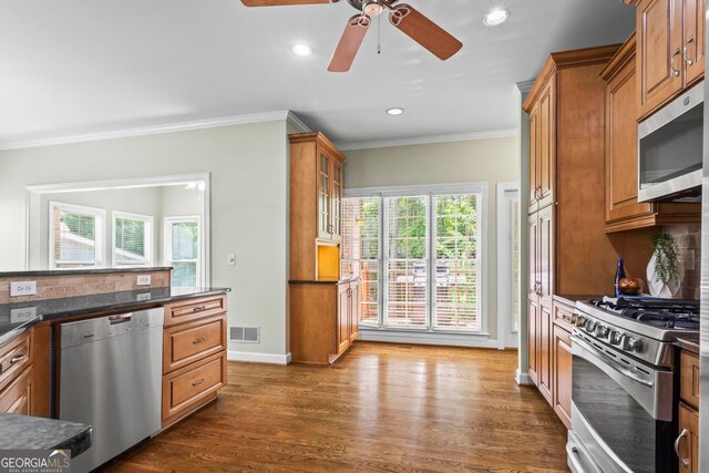 1605 Spinnaker Dr, Alpharetta, GA 30005 - kitchen featuring stainless steel appliances, dark countertops, ornamental molding, a ceiling fan, and backsplash