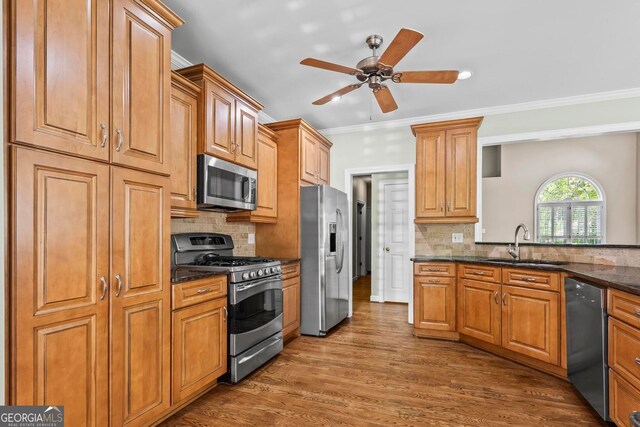 1605 Spinnaker Dr, Alpharetta, GA 30005 - kitchen with appliances with stainless steel finishes, ornamental molding, backsplash, dark wood-style floors, and brown cabinets