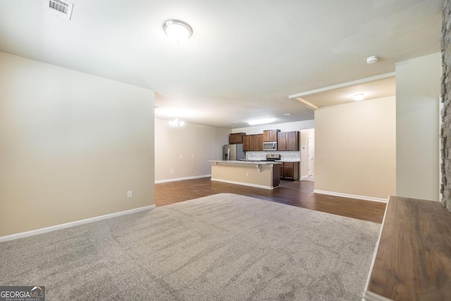 208 Flowing Meadows Dr, Kathleen, GA 31047 - unfurnished living room with baseboards and dark carpet