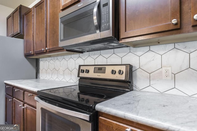208 Flowing Meadows Dr, Kathleen, GA 31047 - kitchen featuring appliances with stainless steel finishes, backsplash, light countertops, and dark brown cabinets
