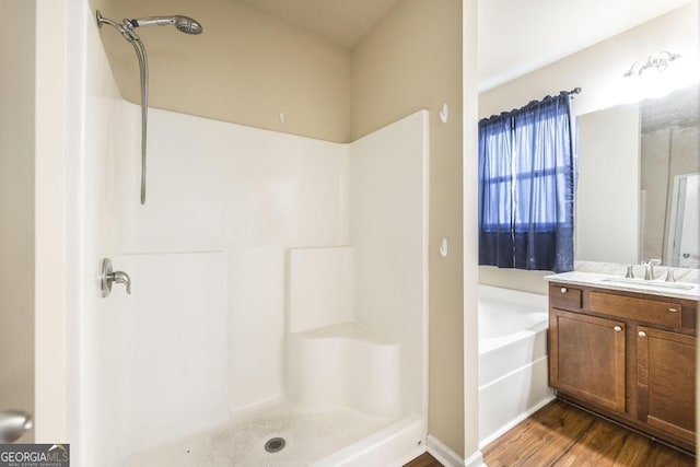 208 Flowing Meadows Dr, Kathleen, GA 31047 - bathroom with vanity, a garden tub, wood finished floors, and a shower