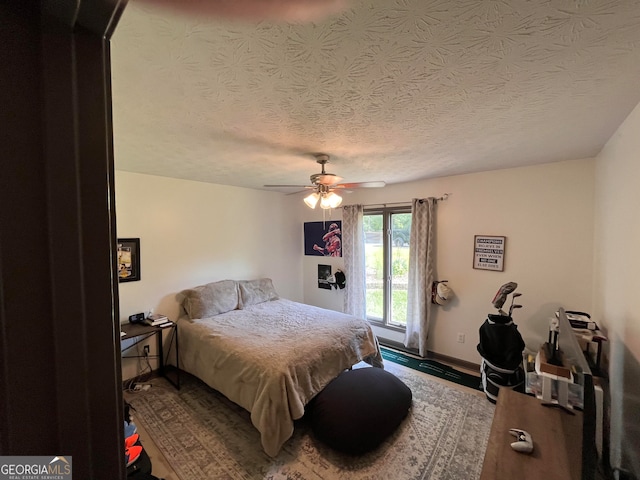 1455 River Cove Rd, Social Circle, GA 30025 - bedroom featuring wood finished floors, a ceiling fan, and a textured ceiling