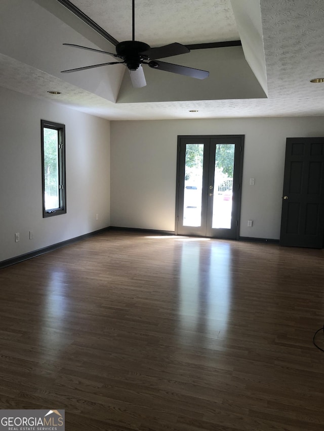 1455 River Cove Rd, Social Circle, GA 30025 - empty room featuring a textured ceiling, a ceiling fan, plenty of natural light, wood finished floors, and french doors