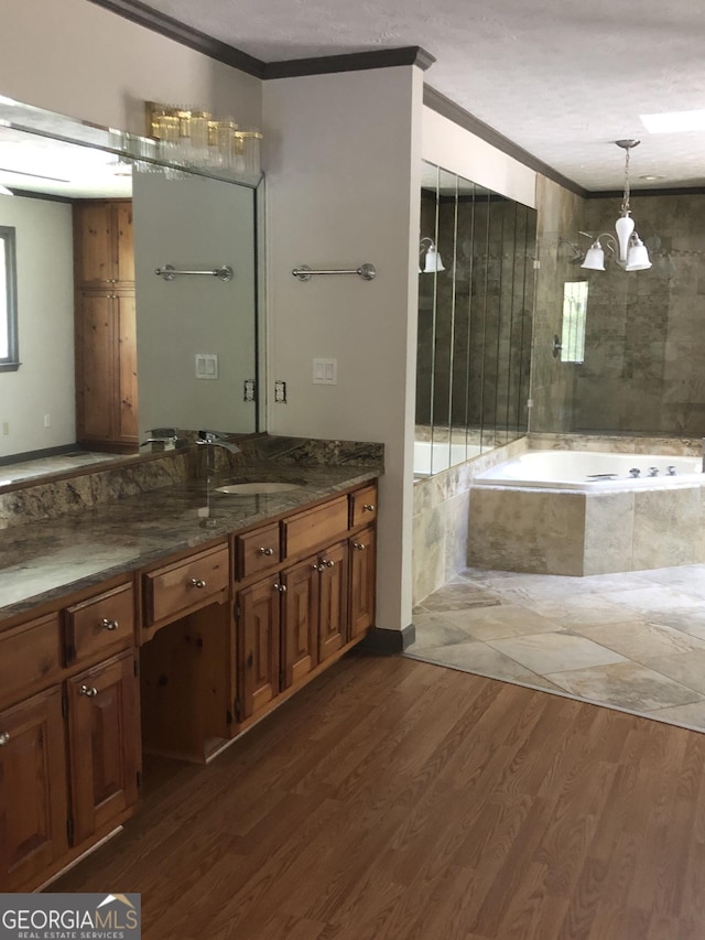 1455 River Cove Rd, Social Circle, GA 30025 - full bath with crown molding, a bath, vanity, a chandelier, and wood finished floors