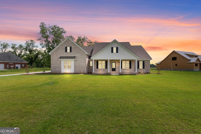 9 Honeysuckle Dr, Claxton, GA 30417 - view of front of house with a front yard, brick siding, and covered porch