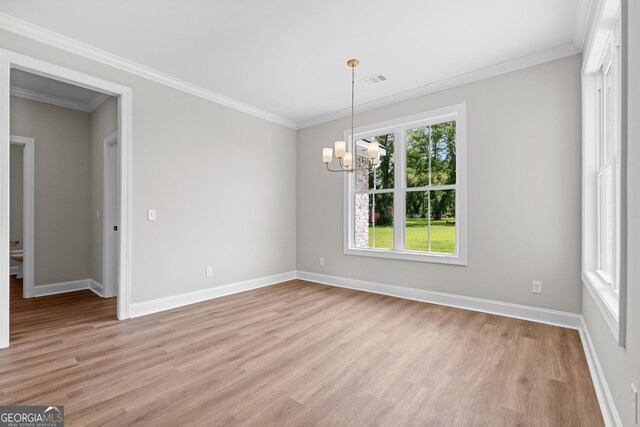 9 Honeysuckle Dr, Claxton, GA 30417 - unfurnished room featuring a chandelier, light wood-type flooring, and crown molding